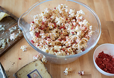 Clear bowl of cheddar and strawberry popcorn for movie night