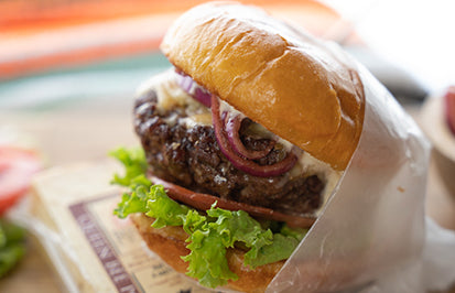 Juicy stuffed mushroom burger topped with Cheddar and red onions