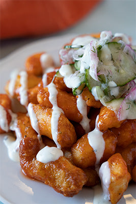 Fried cheese curds with a ranch drizzle
